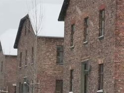 MS PAN Shot of across building at Auschwitz with snow rain / Auschwitz-Birkenau, Krakow, Poland Stock Footage
