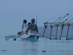 MS Three men riding canoe / Rinca Island,  Indonesia Stock Footage
