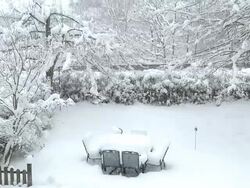 WS Heavy snow layer on furniture of garden at heavy snowfall / Saarburg, Rhineland-Palatinate, Germany Stock Footage