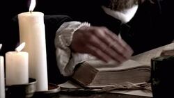 Nostradamus reads a book by the light of a candle. Stock Footage