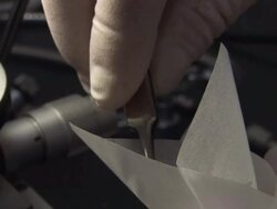 Close Up static - Tweezers place particles into a paper receptacle. / USA Stock Footage