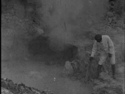 A guide stabs a stick in a thin volcanic crust Stock Footage