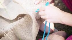 Hands sewing the natural material fabric Stock Footage