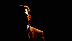 A businessman stands in shadows. Stock Footage