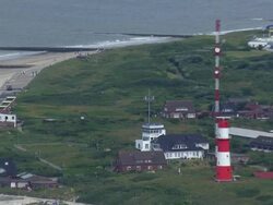 MS AERIAL ZO View of lighthouse at Isle of Borkum in North Sea / Borkum, Lower Saxony Stock Footage