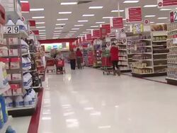 Various people push shopping cars at Target store Stock Footage