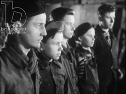 Miners cutting wood and young boys at the mine. France, 1952 Stock Footage