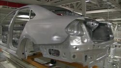 An auto body moves along a conveyor belt. Stock Footage