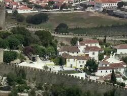 AERIAL WS ZO Medieval walls embracing town / Obidos, Leria, Portugal Stock Footage