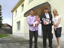HD CRANE: Realtor Posing With A Family Stock Footage