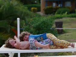 MS Little boy and little girl wrestling and playing together on chair outside / Montezuma, Nicoya Peninsula, Costa Rica  Stock Footage