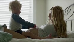 Medium slow motion shot of son listening to belly of pregnant mother / Cedar Hills, Utah, United States Stock Footage