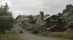 Car driving by a workers' mill, 1930s - reenactment Stock Footage