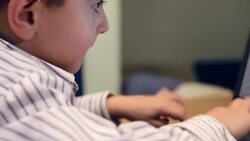 Little boy typing on laptop Stock Footage
