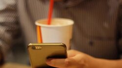 man using smartphone while drinking softdrink Stock Footage