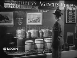 1952: NEW ORLEANS: INTERNATIONAL TRADE MART: TU Angled WS Building on corner of block. VS Merchandise displays, German company display w/ barrels & bales of wire, Logan Perkins model construction site, sand, miniature heavy equipment. Instructional Video