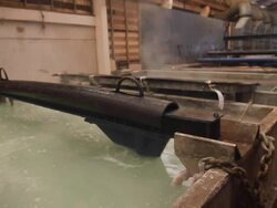 Steel Mill - Coils lifted from bath Stock Footage