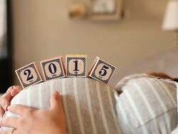 A pregnant women using blocks to spell the word 2015 on her stomach. Stock Footage