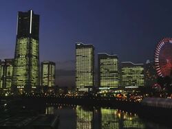 Light-up of the Skyline of Minato Mirai 21 with Cosmo World Ferries Wheel, Time Lapse, Yokohama, Japan Stock Footage