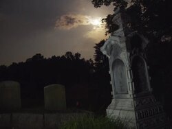 tombstone at night with full moon Stock Footage