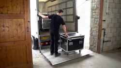 Roadie loads Truck with flightcases and Sound system Stock Footage