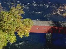 MS AERIAL ZI Shot of West Cornwall Covered Bridge on river / Connecticut, United States Stock Footage