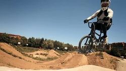 HD SLOW MOTION: Bmx Rider Racing On The Track Stock Footage