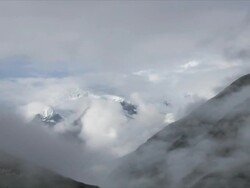 T/L cloud swirling around Yak Kharka at dawn, Himalayas Stock Footage