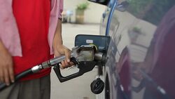 Women pumps fuel at a gas station Stock Footage