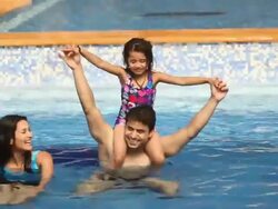 Family playing in a swimming pool Stock Footage