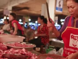 MS POV SLO MO Women vendors weighing and chopping meat at meat market / Vientiane, Laos Stock Footage