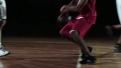 SLO MO of basketball player dribbling two opponents Stock Footage