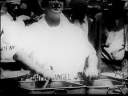 B/W 1931 woman serving food with both hands very quickly at soup kitchen / San Francisco Stock Footage