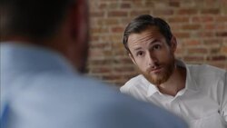 Restaurant waiter listens to instructions from boss during daily meeting Stock Footage