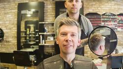 Male Hair stylist holding up a mirror Stock Footage