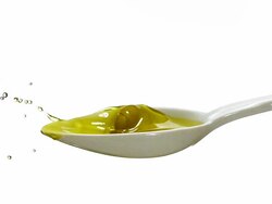 CU SLO MO Olive falling into spoon with fulled of olive oil against white background / Vieux Pont, Normandy, France Stock Footage