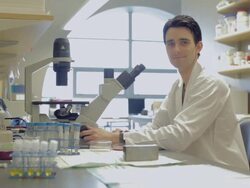MS PAN Male laboratory technician looking into microscope in Cancer research Healthcare medicine  Industry DNA sequencing  Laboratory / Vancouver, BC, Canada   Stock Footage