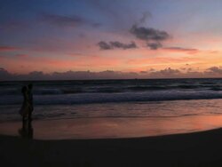 Good Looking Young Couple walking by the Sea at Sunset Stock Footage