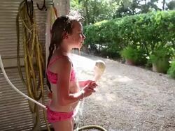 MS TU TD Young girl rinsing herself off in outdoor shower / St. Simon's Island, Georgia, United States Stock Footage