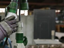Caucasian factory worker's hands unplug an industrial machine from a power source Stock Footage