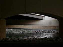 WS Young man running underneath of  bridge while exercising / Minneapolis, Minnesota, United States Stock Footage