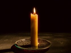 Time-Lapse Single candle burning down as camera tracks in  to close up Stock Footage