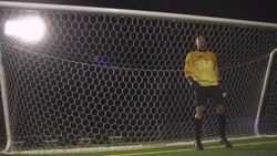 A goalie shuffles his feet before diving to save the soccer ball from going in the net. Stock Footage