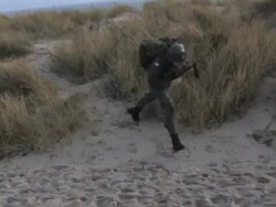 soldiers running on the beach steadycam shot Stock Footage