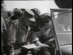 B/W 1950's Douglas MacArthur talking to soldiers in off-road vehicle / Korea / NO SOUND Stock Footage