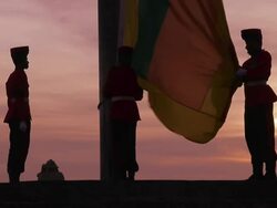 MS Montage of honour guard in full military dress lowering national Sri Lanka flag at dusk on 'Galle Face Green' / Colombo, Western Province, Sri Lanka Stock Footage