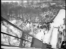 B/W 1962 high angle REAR VIEW skier going down jump in competition / Chamonix, France / newsreel Stock Footage