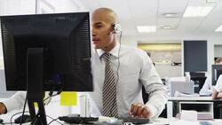 Businessman wearing headset using computer Stock Footage