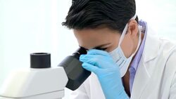 Analyzing specimens under the microscope Stock Footage