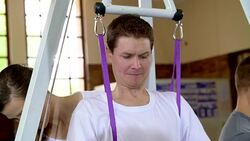 Physical therapist helping man with spinal injury in hoist Stock Footage